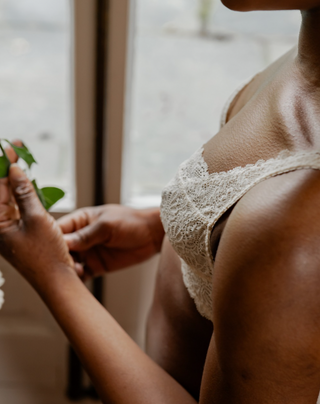 Close up shot of a model wearing Aberdevines, soft, lacy, white underwire bra